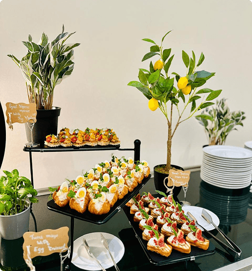 Catering table with greenery and plated dishes